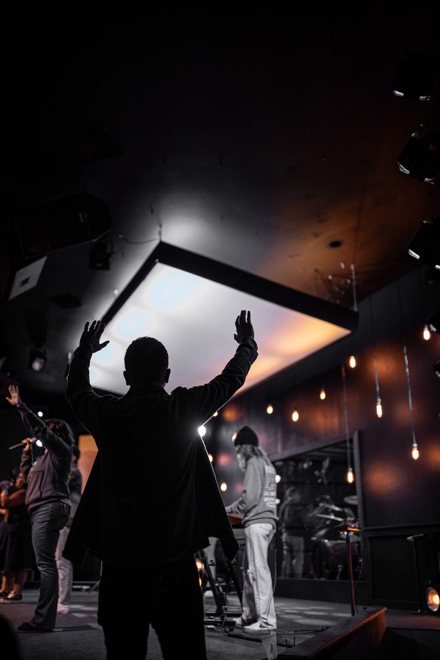 Hands raised in worship during a Motion Church service